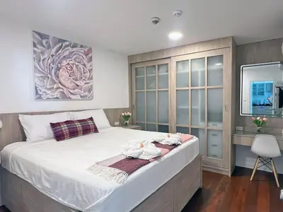a bedroom with a large bed with white sheets at Bliss Patong - 2Br Sea View Condo - Roof Top Pool in Patong Beach