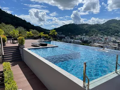 a large swimming pool on top of a building at Bliss Patong - 2Br Sea View Condo - Roof Top Pool in Patong Beach