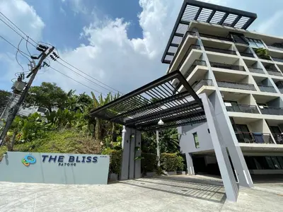 a building with a sign in front of it at Bliss Patong - 2Br Sea View Condo - Roof Top Pool in Patong Beach