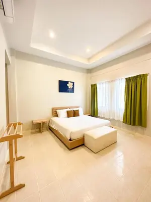 a large bedroom with a bed and a window at Favorite Place in Kata Beach