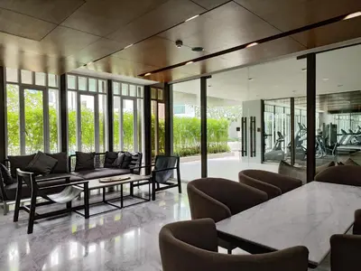 a living room with couches and tables and windows at 5 Floor - The Base Downtown Condominium next to Central Shopping Mall in Phuket Town