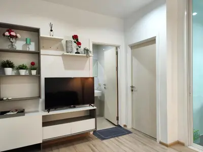 a living room with a flat screen tv on a wall at 5 Floor - The Base Downtown Condominium next to Central Shopping Mall in Phuket Town