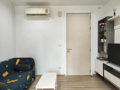 a living room with a couch and a tv at 5 Floor - The Base Downtown Condominium next to Central Shopping Mall in Phuket Town