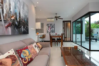 a living room with a couch and a table at Private Pool Villa Nai Harn Beach in Rawai Beach