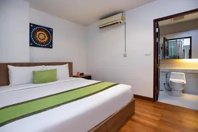 a bedroom with a white bed and a toilet at iCheck inn Residences Patong in Patong Beach