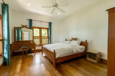 a bedroom with a bed and a mirror and a piano at Aoyon Beach, a 5-bedroom Thai-style villa with stunning sea views, 50 meters direct beach access, free maid, in Phuket Town