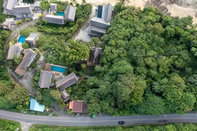 an overhead view of a forest with houses and a road at Aoyon Beach, a 5-bedroom Thai-style villa with stunning sea views, 50 meters direct beach access, free maid, in Phuket Town