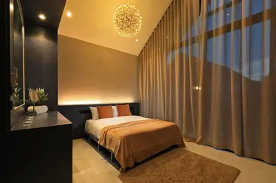 a bedroom with a bed and a chandelier at 3bdr Granary Pool Villa Bangtao Beach by CapitalPro GRN-A4 in Phuket Town