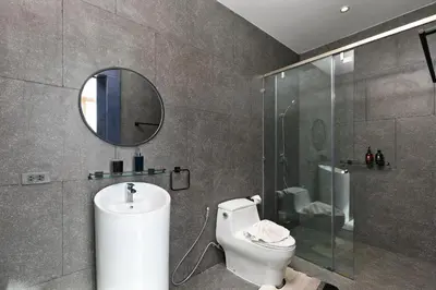 a bathroom with a toilet and a shower and a mirror at 3bdr Granary Pool Villa Bangtao Beach by CapitalPro GRN-A4 in Phuket Town