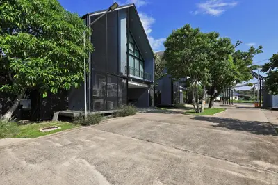 a black building with a road in front of it at 3bdr Granary Pool Villa Bangtao Beach by CapitalPro GRN-A4 in Phuket Town