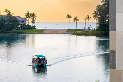 a small boat on a body of water at Cassia 1 BR Sea View apt by NLA in Bang Tao Beach
