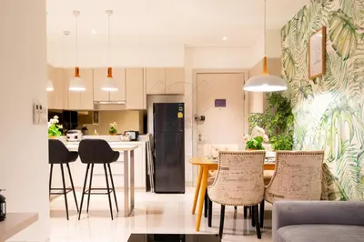 a kitchen and living room with a table and chairs at Cassia 2 BR Sea View&Terrace apt by NLA in Bang Tao Beach