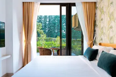 a bedroom with a white bed and a large window at Cassia 2 BR Sea View&Terrace apt by NLA in Bang Tao Beach