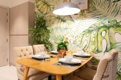 a dining room with a table with chairs and a mural at Cassia 2 BR Sea View&Terrace apt by NLA in Bang Tao Beach