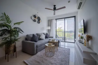 a living room with a couch and a table at Cassia 2 BR Lake&Road View apt by NLA in Bang Tao Beach