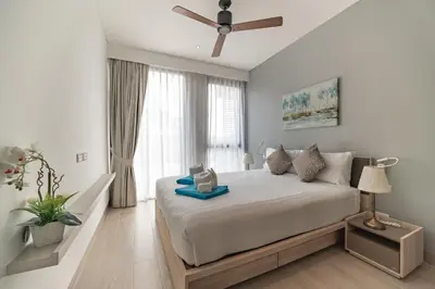 a bedroom with a bed and a large window at Cassia 2 BR Lake&Road View apt by NLA in Bang Tao Beach