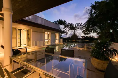 a patio with a glass table and chairs at Katamanda Villa Mila A1 near Kata Beach in Kata Beach