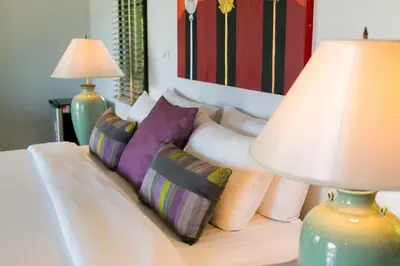 a bedroom with a bed with pillows and a lamp at Katamanda Villa Mila A1 near Kata Beach in Kata Beach