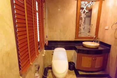 a bathroom with a sink and a toilet and a mirror at Classic Thai style Cozy Villa fancy pool+garden in Patong Beach