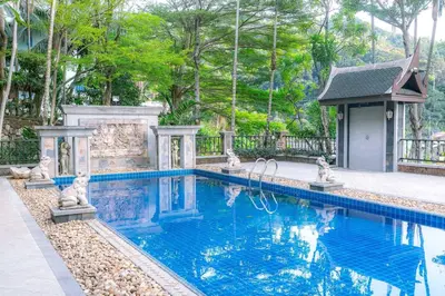 a swimming pool in a backyard with a gazebo at Classic Thai style Cozy Villa fancy pool+garden in Patong Beach