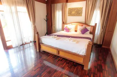 a bedroom with a bed with two plates on it at Classic Thai style Cozy Villa fancy pool+garden in Patong Beach