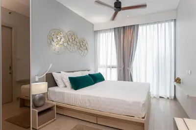 a white bedroom with a bed and a large window at Cassia 1 BR Lake&Pool View apt by NLA in Bang Tao Beach