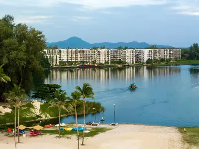 a view of a lake with buildings and palm trees at Cassia 1 BR Lake&Pool View apt by NLA in Bang Tao Beach