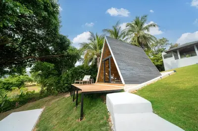 a small house with a roof on top of a field at Full Seaview 5BR Villa Serenity, Elite Living at Cape Yamu in Ban Bang La