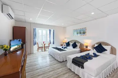 a hotel room with two beds and a flat screen tv at Bevans Place Karon in Karon Beach