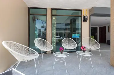 a group of white chairs sitting on a patio at Bevans Place Karon in Karon Beach