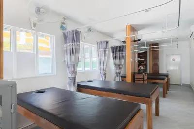 a dining room with a table and some windows at Bevans Place Karon in Karon Beach