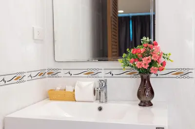 a bathroom sink with a vase of flowers on it at Bevans Place Karon in Karon Beach