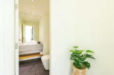 a bathroom with a toilet and a sink and a mirror at Cozy 5BR Villa Stunning SeaViews in Kamala Beach