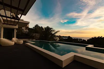 a swimming pool with a view of the ocean at Cozy 5BR Villa Stunning SeaViews in Kamala Beach