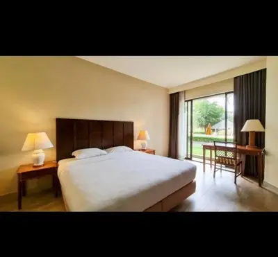 a bedroom with a large bed and a large window at Golf View, Allamanda 3 Apartment in Ban Mut Dok Khao