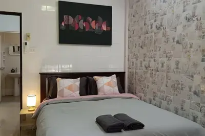 a bedroom with a bed with two towels on it at Naka Tangerine Holiday Home by Bcare in Ban Rangeng