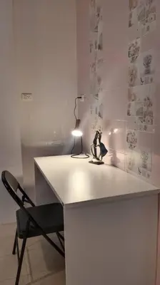 a white desk with a lamp and a black chair at Naka Tangerine Holiday Home by Bcare in Ban Rangeng