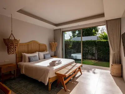 a bedroom with a bed and a large window at Exclusive Villa Botanica in Bang Tao Beach