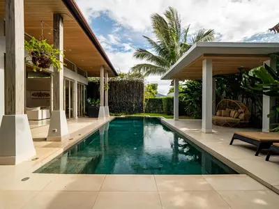 a swimming pool in a villa with a house at Exclusive Villa Botanica in Bang Tao Beach