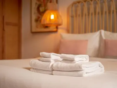 a pile of towels sitting on top of a bed at Exclusive Villa Botanica in Bang Tao Beach