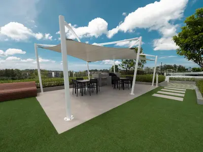 a pavilion with tables and chairs under a white canopy at Laguna SkyPark new brand apartments in Phuket Town