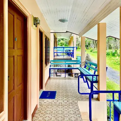 a porch with blue benches on a house at Chamil House (ชามิล เฮ้าส์) in Ban Ko En