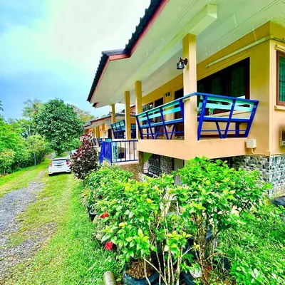 a house with a balcony and a car parked next to it at Chamil House (ชามิล เฮ้าส์) in Ban Ko En