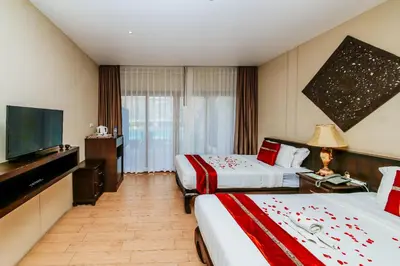 a hotel room with two beds and a flat screen tv at Blue Bay Resort - Access to Pool and Beach-Phuket & Krabi in Ko Yao Yai