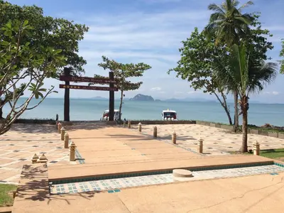 a wooden walkway leading to a beach with the ocean at Blue Bay Resort - Access to Pool and Beach-Phuket & Krabi in Ko Yao Yai
