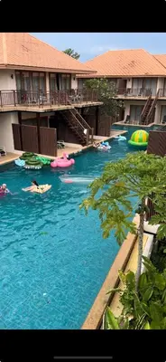 a resort swimming pool with people in the water at Blue Bay Resort - Access to Pool and Beach-Phuket & Krabi in Ko Yao Yai