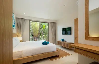 a bedroom with a bed and a large window at 3-Bedroom Pool Villa in Trichada Sky at Bangtao in Bang Tao Beach