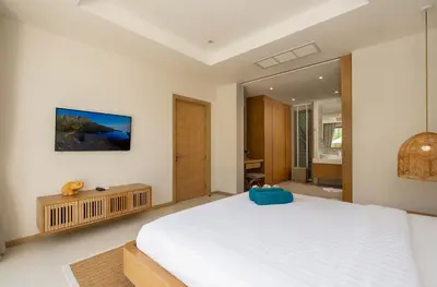 a bedroom with a large white bed and a mirror at 3-Bedroom Pool Villa in Trichada Sky at Bangtao in Bang Tao Beach