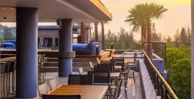 a row of tables and chairs on a patio at Kamala Beach D723 Exclusive 2 bedroom Suite in Kamala Beach