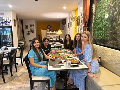 a group of women sitting at a table eating food at Istanbul Boutique Hotel in Patong Beach